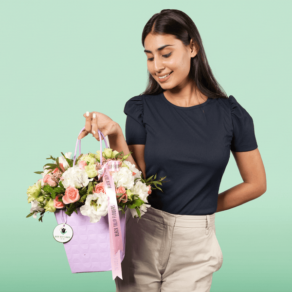 White and pink Disbud Chrysanthemum, Eustoma and Hypericum arrangement in a lavender flower gift bag.