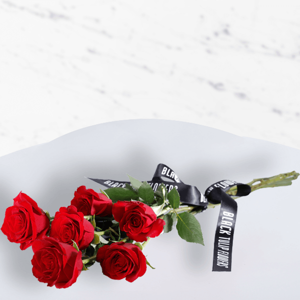 A luxury bouquet of 50 red roses in white wrap.