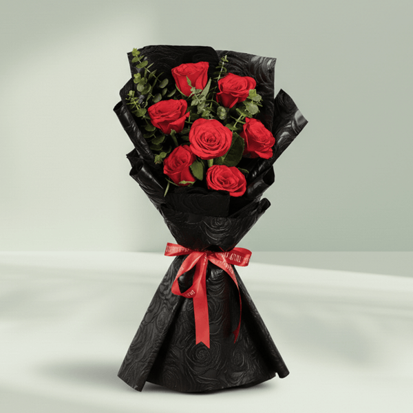 7 red roses bouquet with eucalyptus in black wrapping