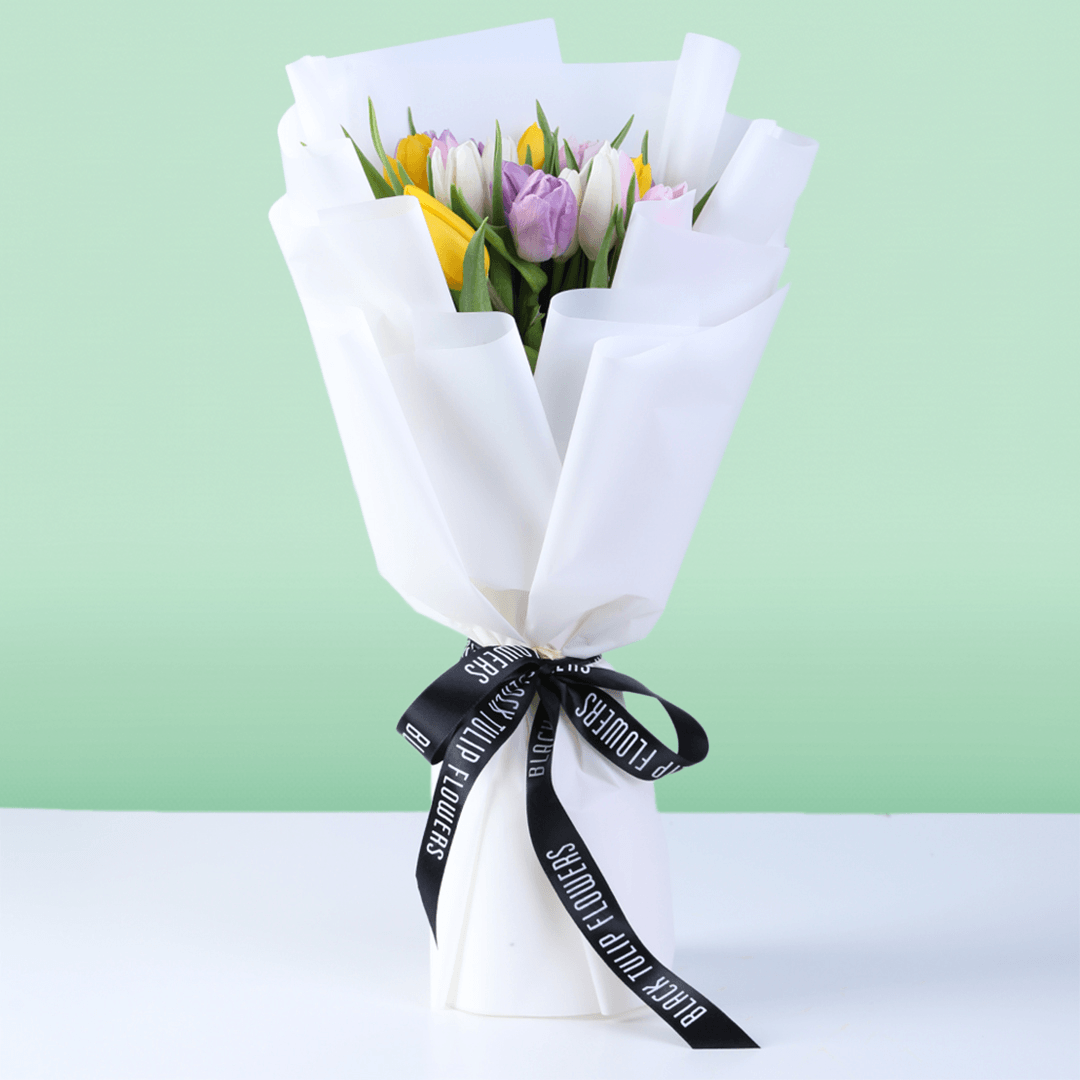 Mixed fresh tulip bouquet with assorted colored tulips and elegant wrapping.