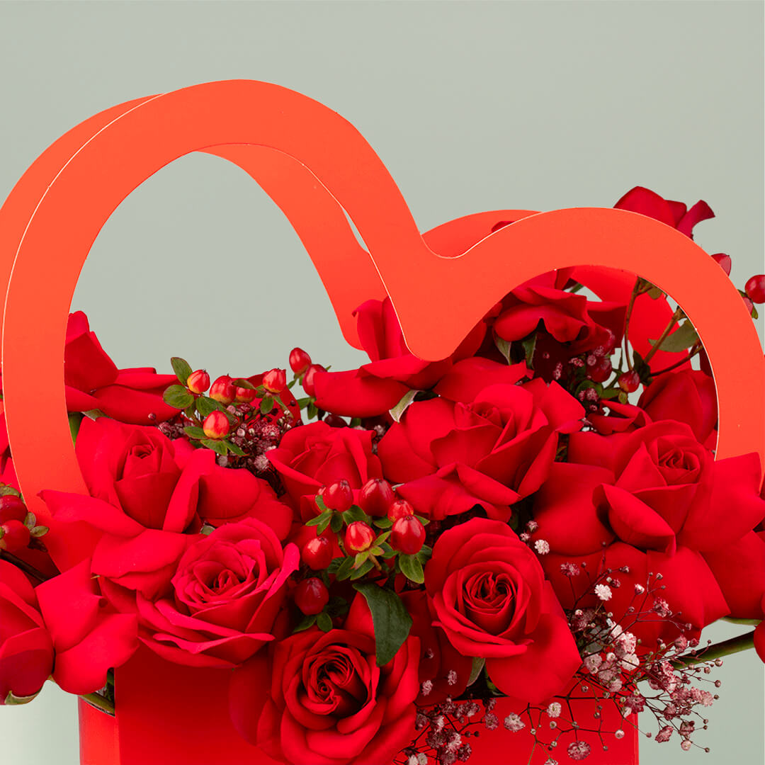 Red roses arranged in a heart-shaped flower box