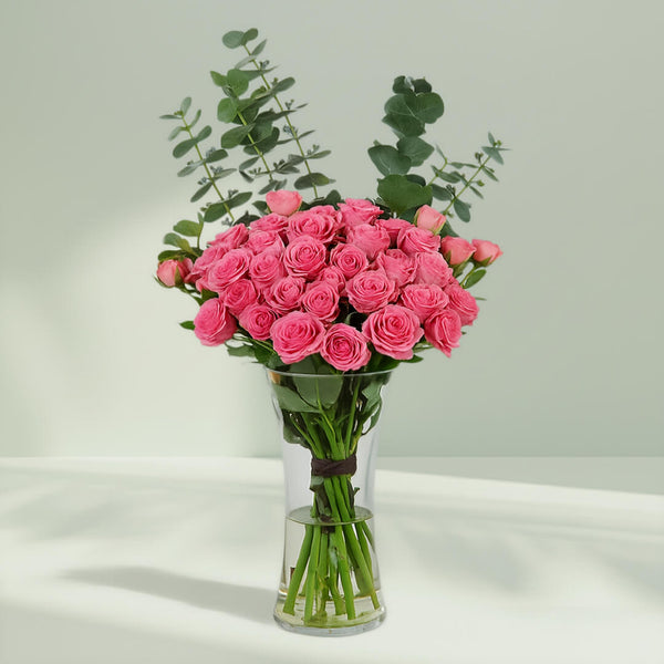 Blush Roses in Glass Vase arranged with 20 blush roses and eucalyptus greens