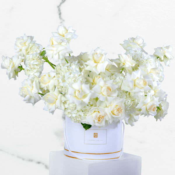 White hydrangea and rose arrangement with 30 blooms in a round white flower box.