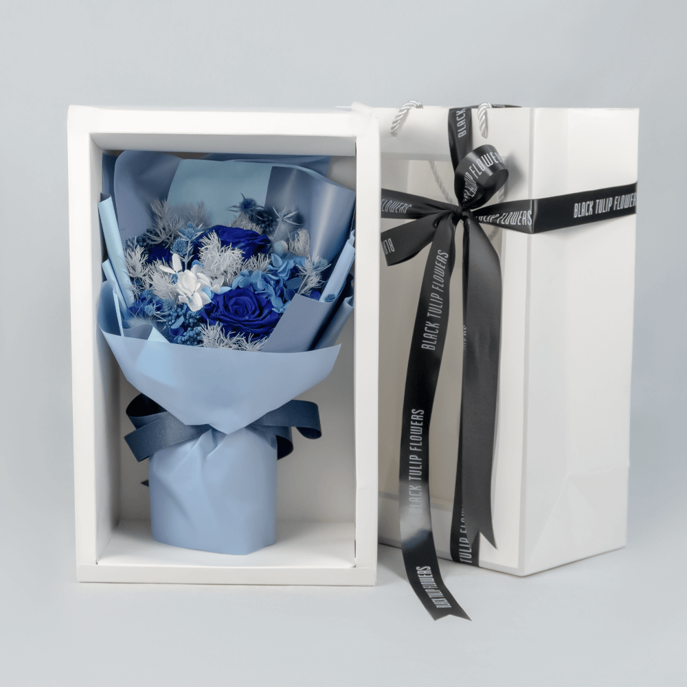 Blue preserved flower bouquet arranged with decorative dried blooms and fillers.