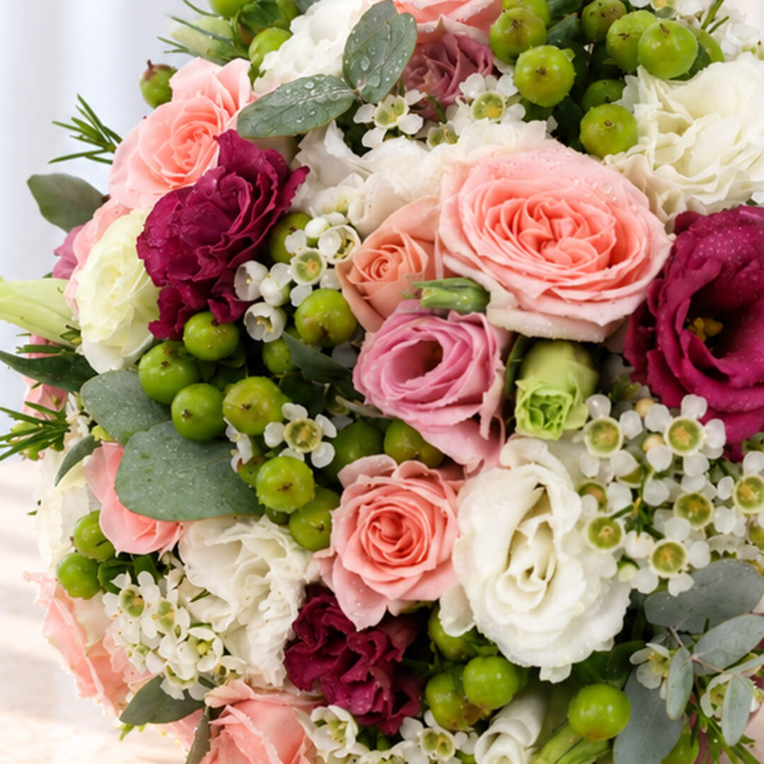 Mixed flower bridal bouquet featuring fresh Eustoma, roses, and eucalyptus