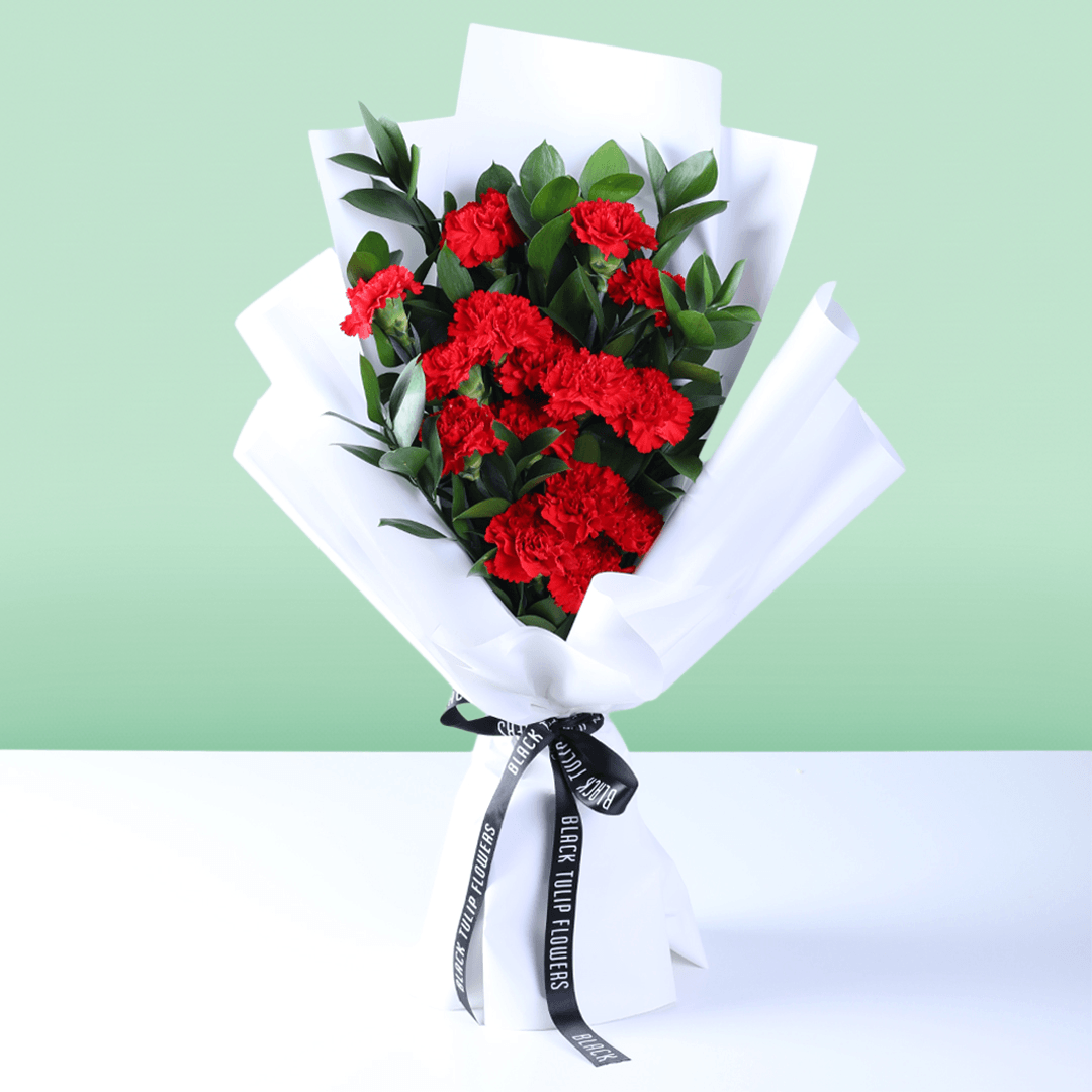 Crimson red carnation bouquet with fresh carnations and elegant wrapping