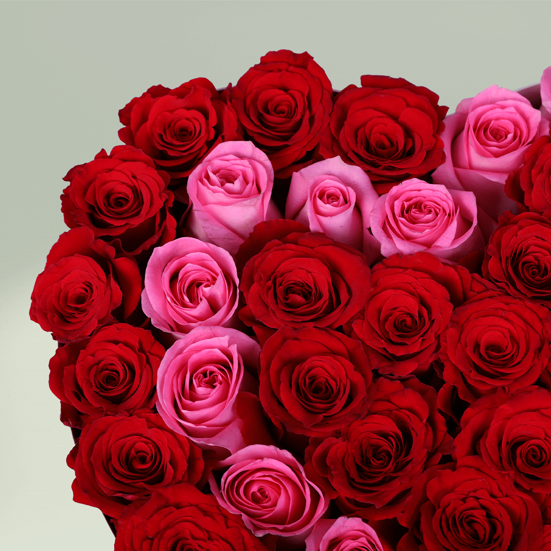 Love Bloom Rose Heart Box arranged with red and pink roses