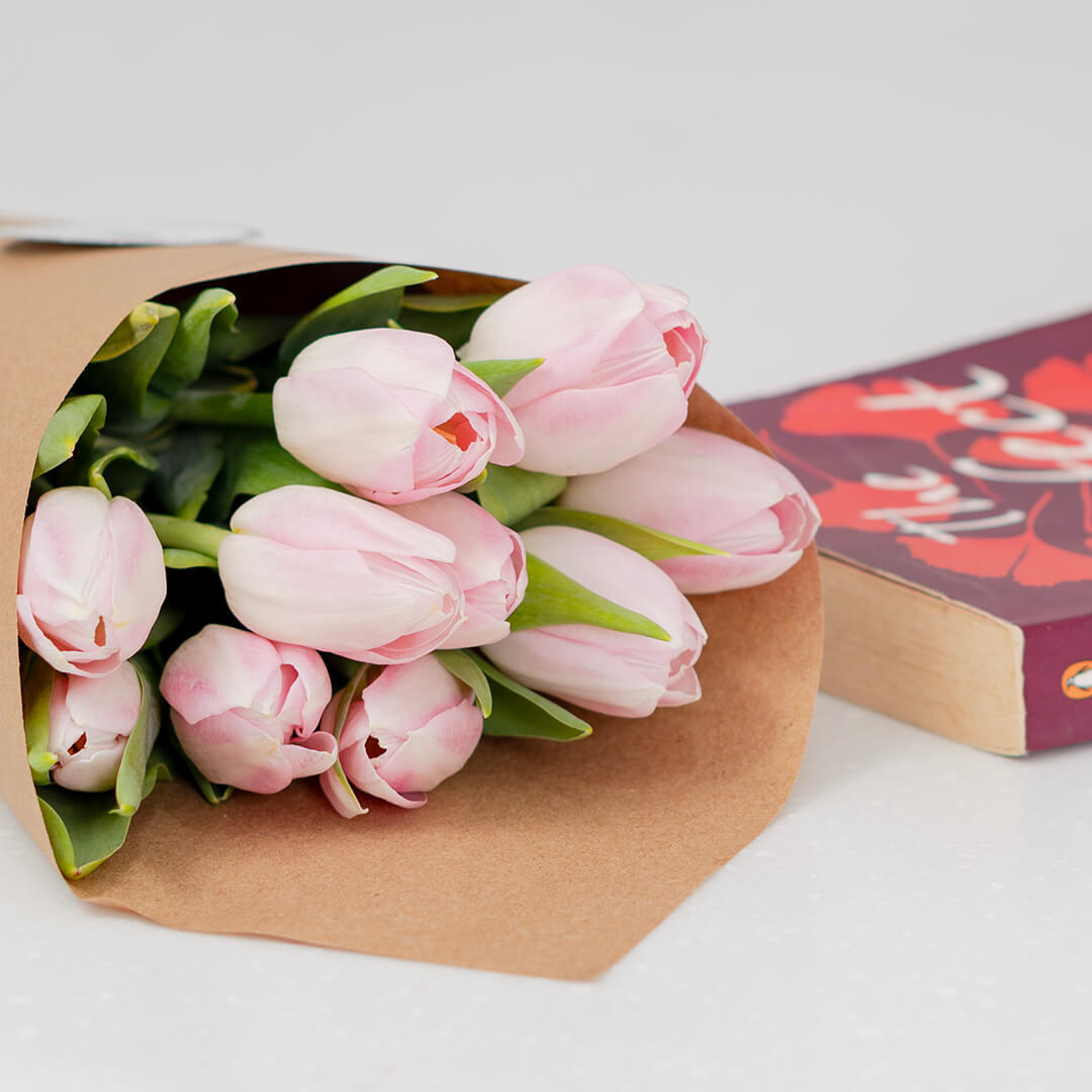 Fresh light pink cut tulip flowers in a bouquet with soft blush petals