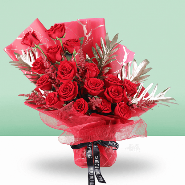 Crimson Passion Red Floral Bouquet arranged with red roses with lush greenery and seasonal red accents