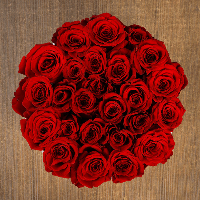 Round flower box featuring 25 to 35 red roses in a premium white box with gold detailing