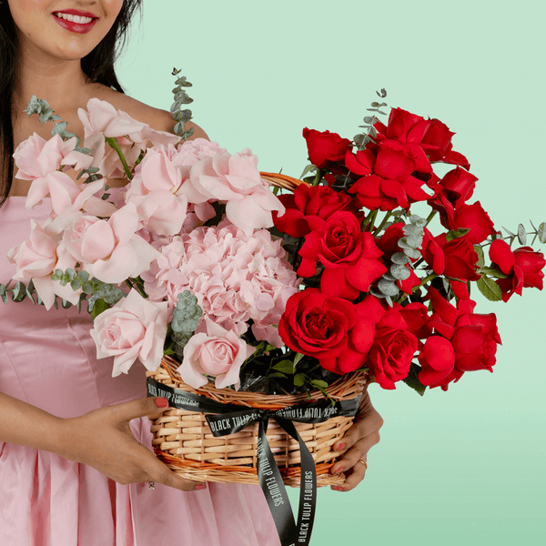 Mixed rose hydrangea basket with eucalyptus in red and pink flower tones