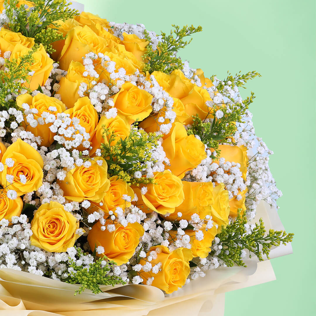 Yellow rose bouquet with gypsophila and non-woven wrapping