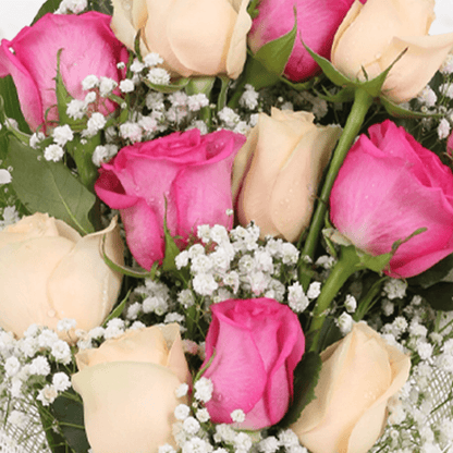 A pastel bouquet of pink and peach roses with fillers in non woven paper wrap.