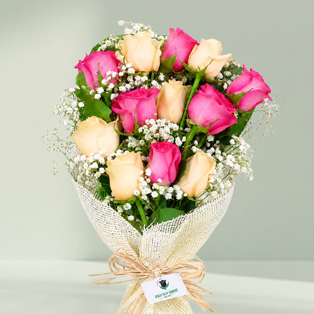 12 stem pink and peach rose bouquet with fillers wrapped in non-woven paper