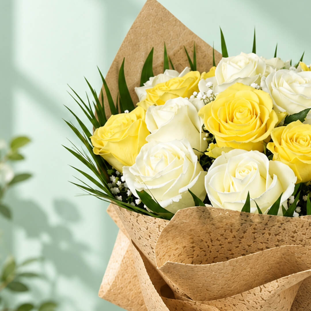 20 yellow and white roses with fresh green leaves arranged as a flower bouquet for gifting