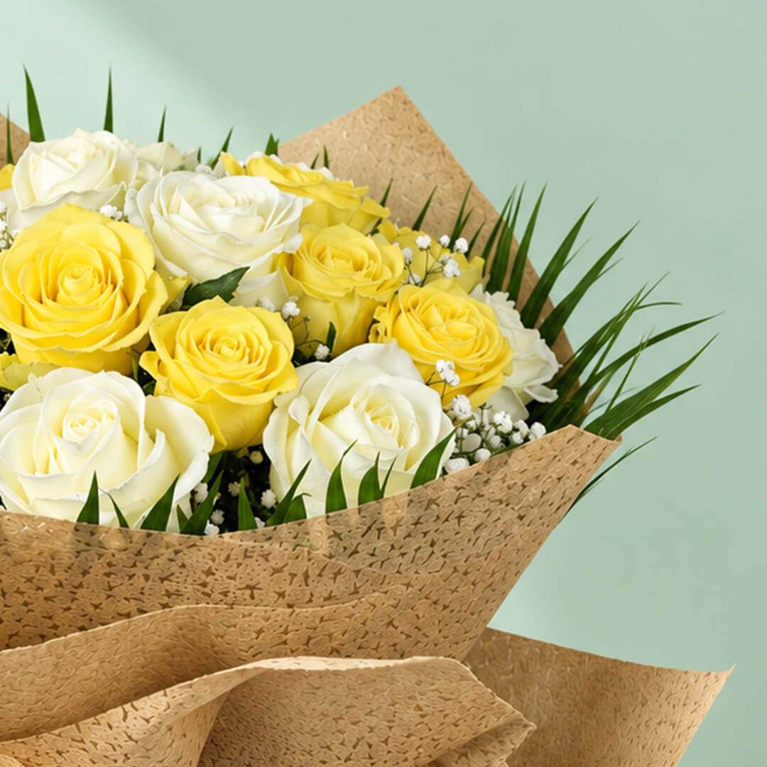 20 yellow and white roses with fresh green leaves arranged as a flower bouquet for gifting