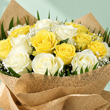 20 yellow and white roses with fresh green leaves arranged as a flower bouquet for gifting