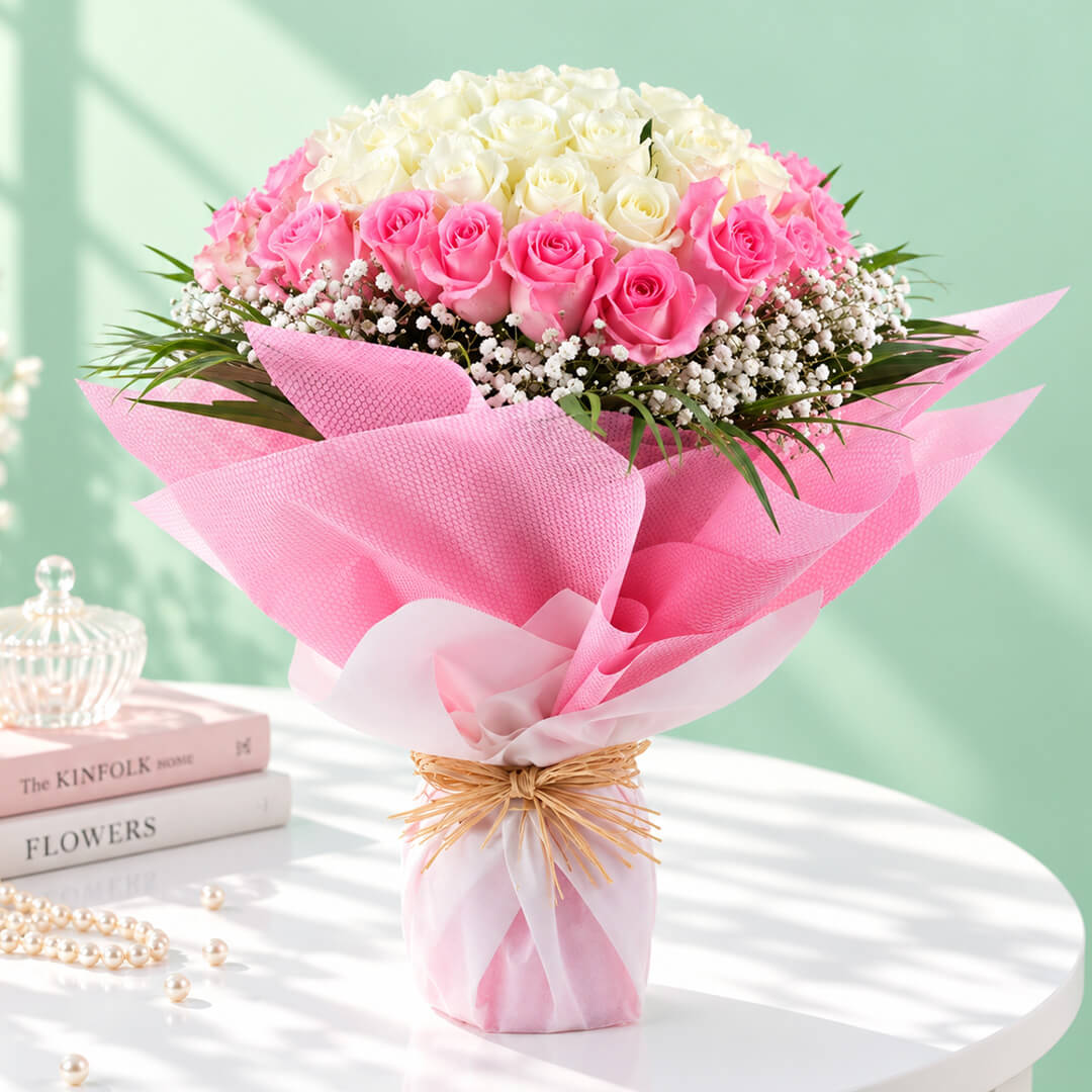 A bouquet of 30 pink roses complemented by delicate white gypso flowers in a soft pink-and-white floral arrangement