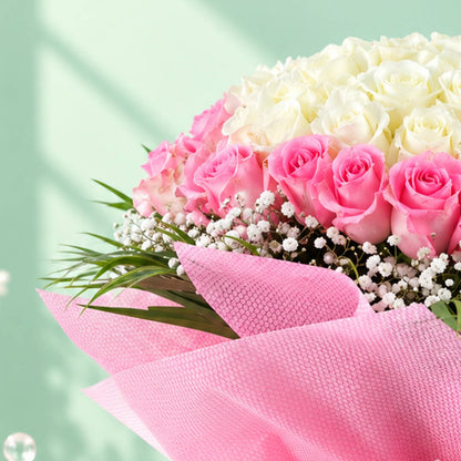 A bouquet of 30 pink roses complemented by delicate white gypso flowers in a soft pink-and-white floral arrangement