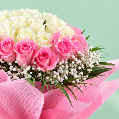 A bouquet of 30 pink roses complemented by delicate white gypso flowers in a soft pink-and-white floral arrangement