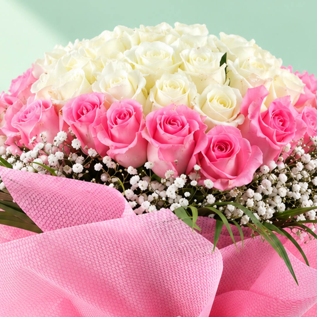 A bouquet of 30 pink roses complemented by delicate white gypso flowers in a soft pink-and-white floral arrangement