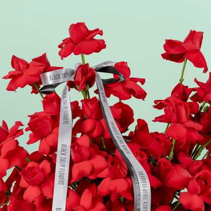 Red Velvet 50 Rose Basket arranged with 50 fresh red roses with lush greenery
