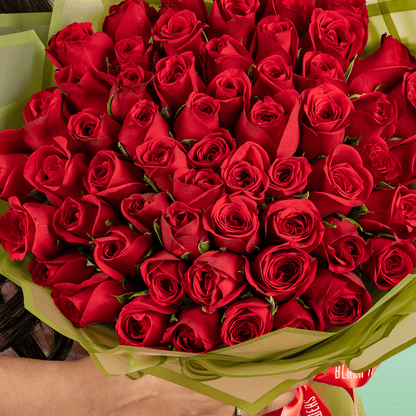 50 Red Rose Love You Bouquet arranged with 50 red roses with fresh fillers and a Love You topper