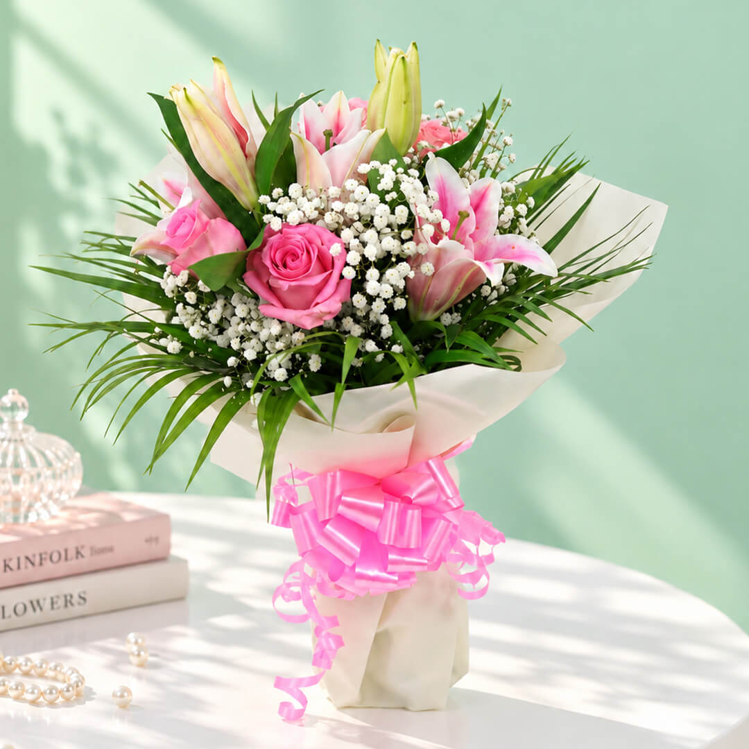 7-stem bouquet of pink lilies and roses with delicate gypso flowers and green leaves