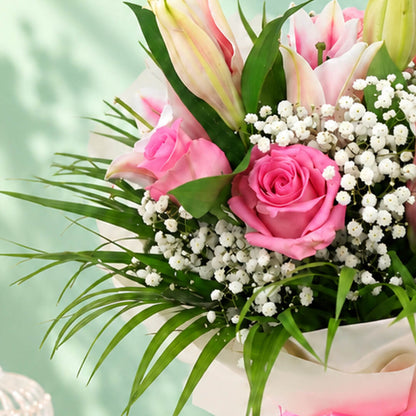 7-stem bouquet of pink lilies and roses with delicate gypso flowers and green leaves