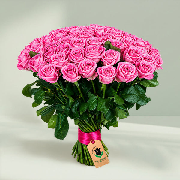 Beautiful luxury pink rose bouquet featuring 75 fresh roses in a lush rounded arrangement
