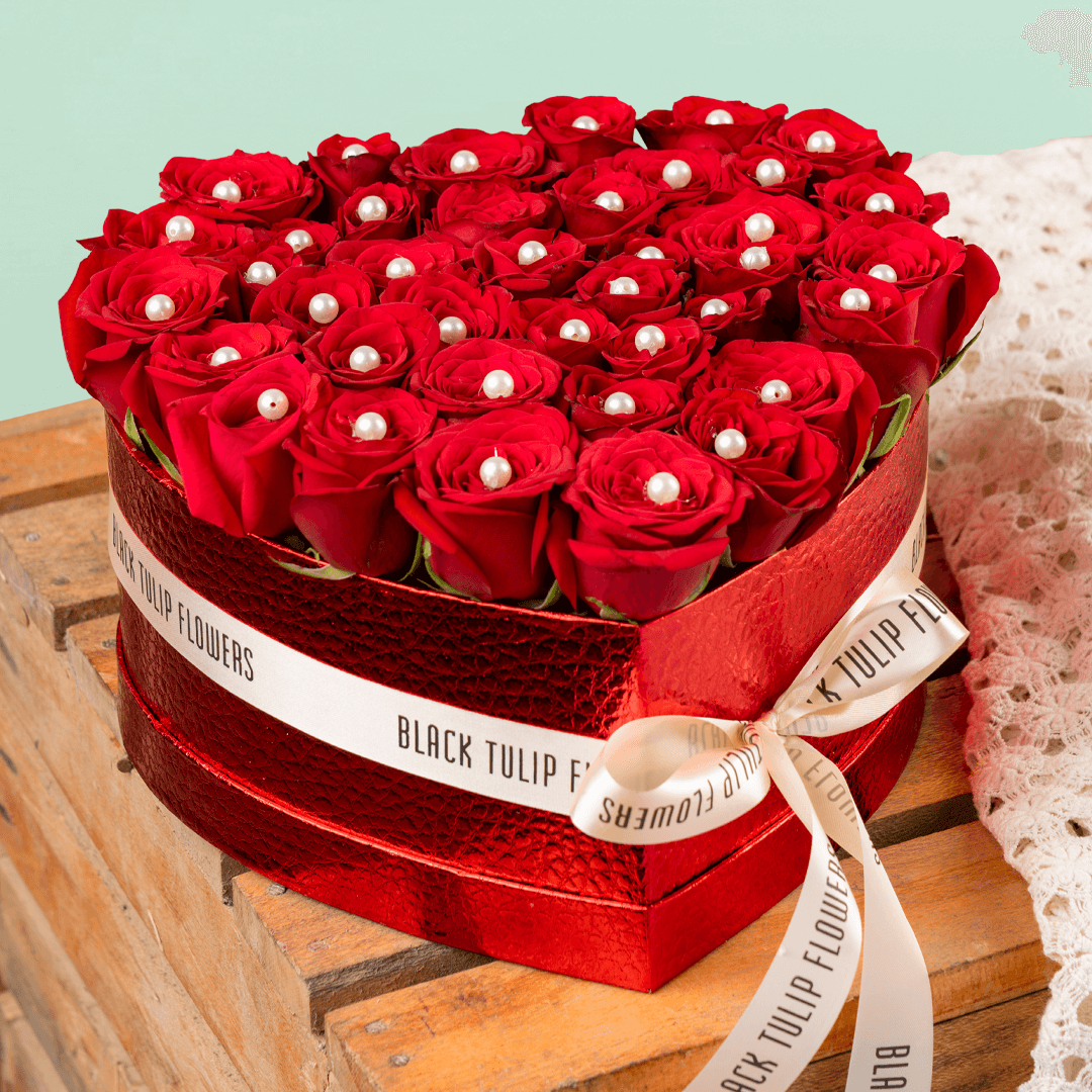 Heart shaped red rose box with pearl accents and ribbon detailing