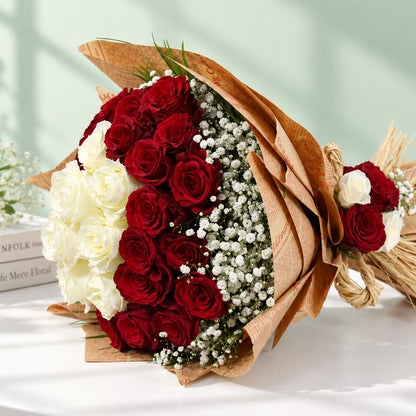 Red and white roses with delicate gypsophila wrapped in brown and cream non-woven paper
