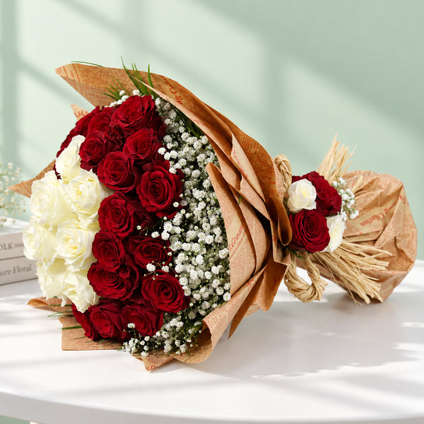 Red and white roses with delicate gypsophila wrapped in brown and cream non-woven paper