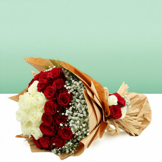 Red and white roses with delicate gypsophila wrapped in brown and cream non-woven paper