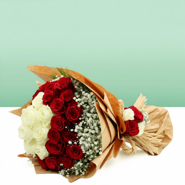 Red and white roses with delicate gypsophila wrapped in brown and cream non-woven paper