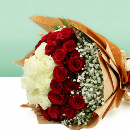 Red and white roses with delicate gypsophila wrapped in brown and cream non-woven paper