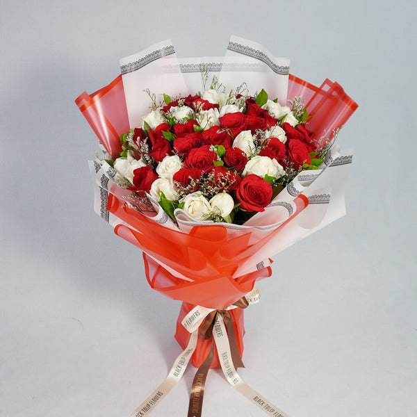 Bouquet of 40 red and white Roses with Limonium wrapped in red and white Korean-style flower sheets.