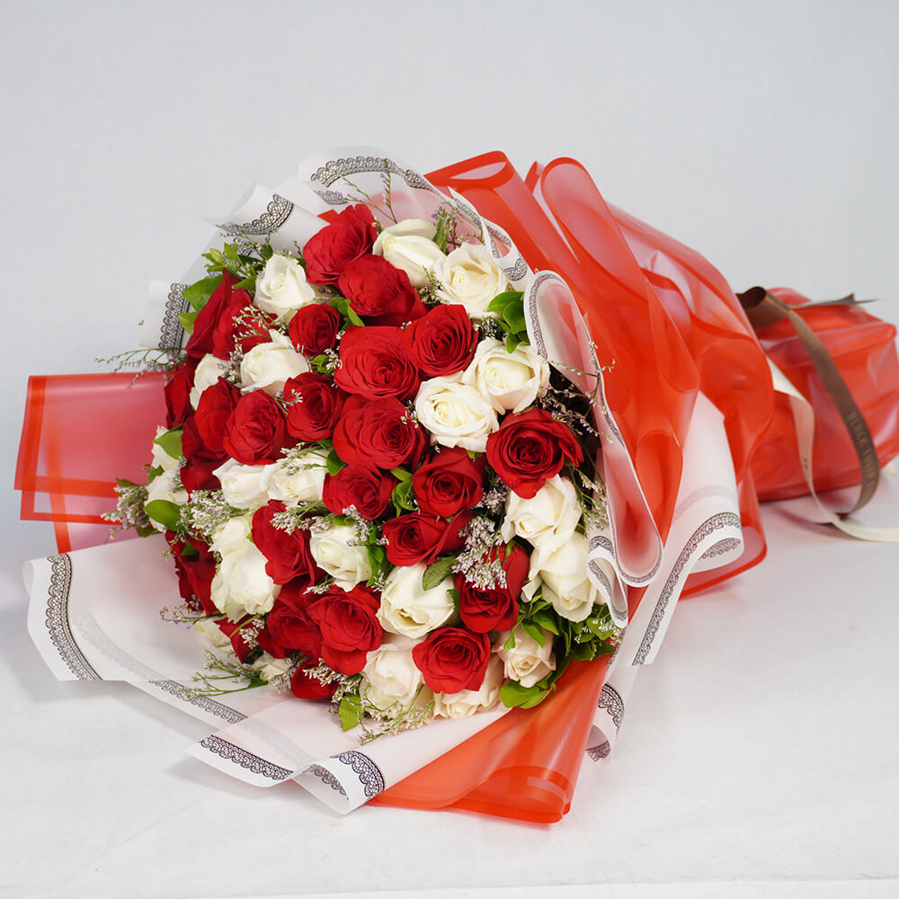 Bouquet of 40 red and white Roses with Limonium wrapped in red and white Korean-style flower sheets.
