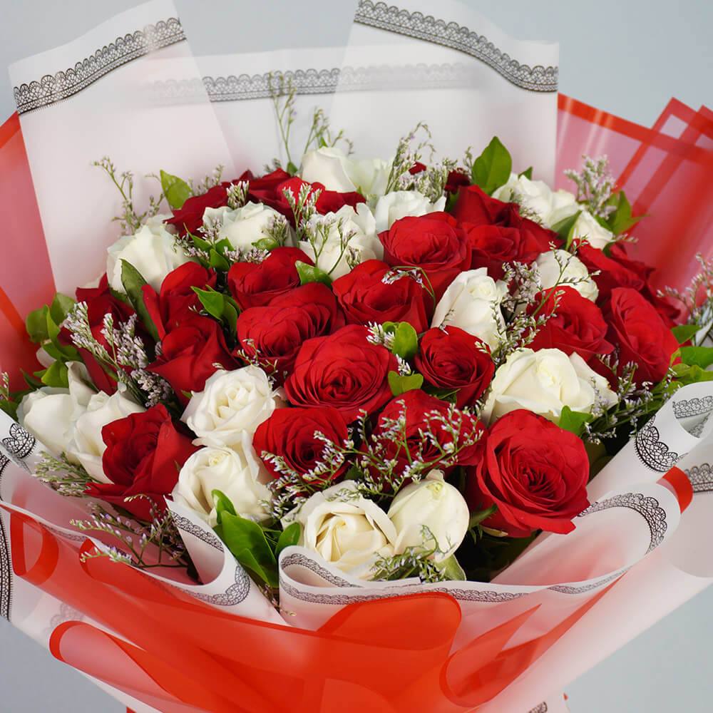 Bouquet of 40 red and white Roses with Limonium wrapped in red and white Korean-style flower sheets.