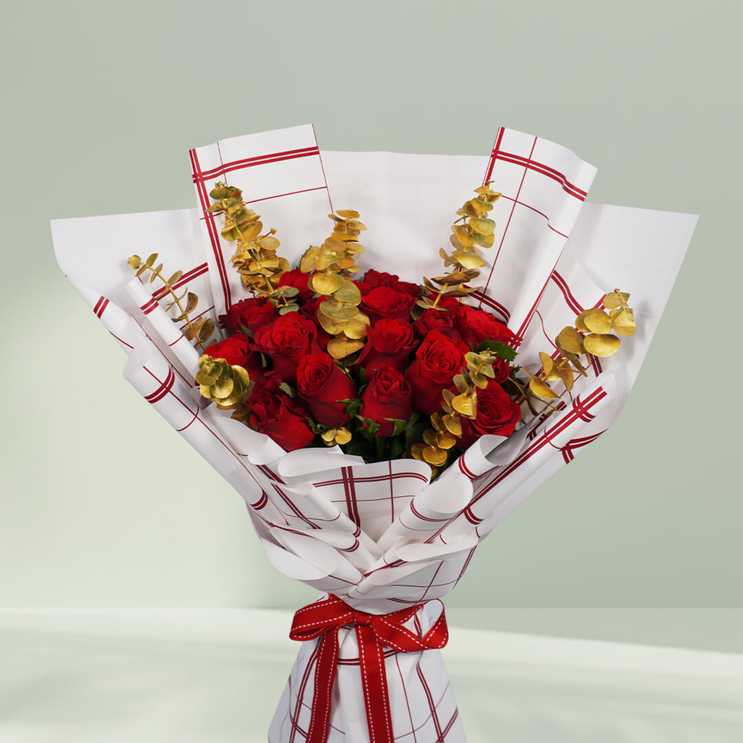 Aurum Roses bouquet with 26 red and gold roses and eucalyptus