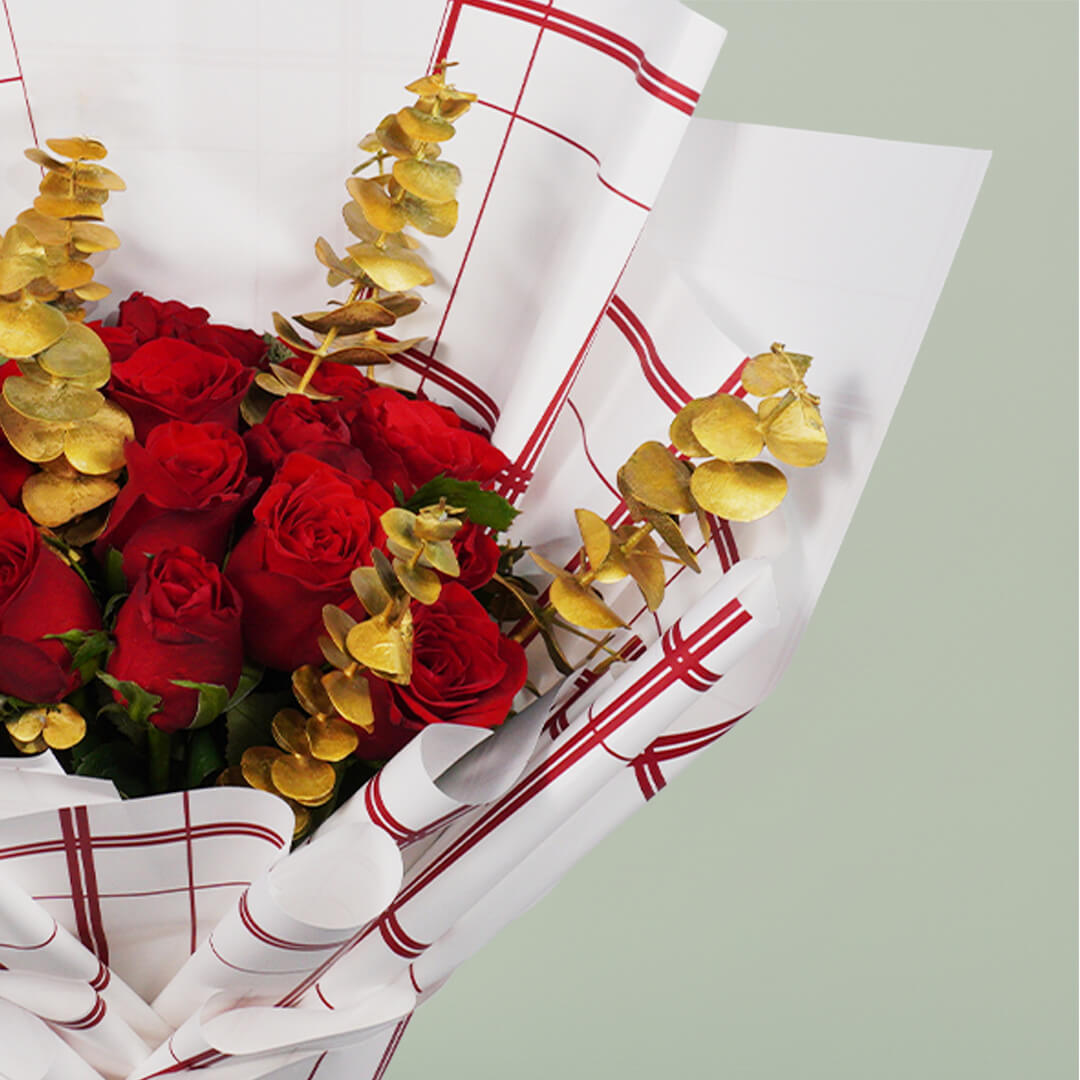 Aurum Roses bouquet with 26 red and gold roses and eucalyptus