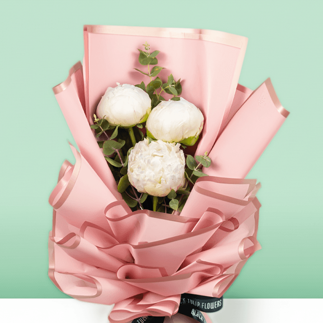 White peonies with green fillers wrapped in Korean-style flower wrapping sheets.
