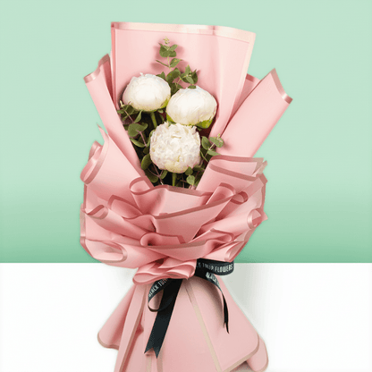 White peonies with green fillers wrapped in Korean-style flower wrapping sheets.