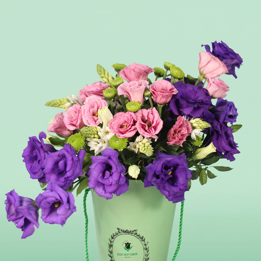 Blooming Elegance arrangement with 30 assorted Eustoma, Ornithogalum and button green chrysanthemums in a curved glass vase