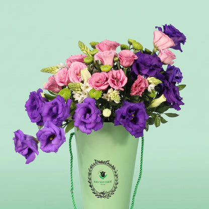 Blooming Elegance arrangement with 30 assorted Eustoma, Ornithogalum and button green chrysanthemums in a curved glass vase