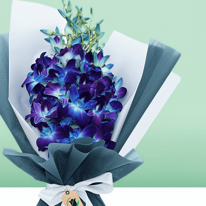 Blue orchid bouquet wrapped in layered blue and white non-woven paper
