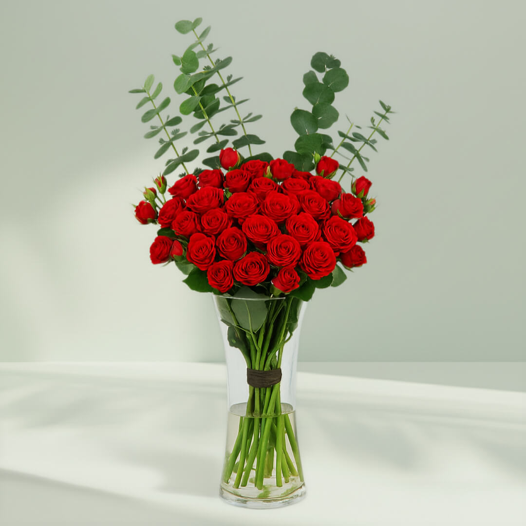 Red Roses in Glass Vase arranged with 20 red roses and eucalyptus