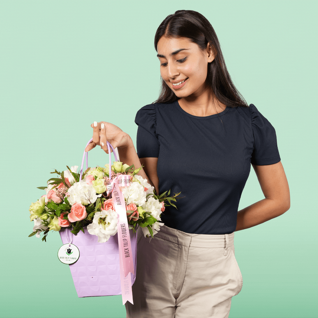 White and pink Disbud Chrysanthemum, Eustoma and Hypericum arrangement in a lavender flower gift bag.
