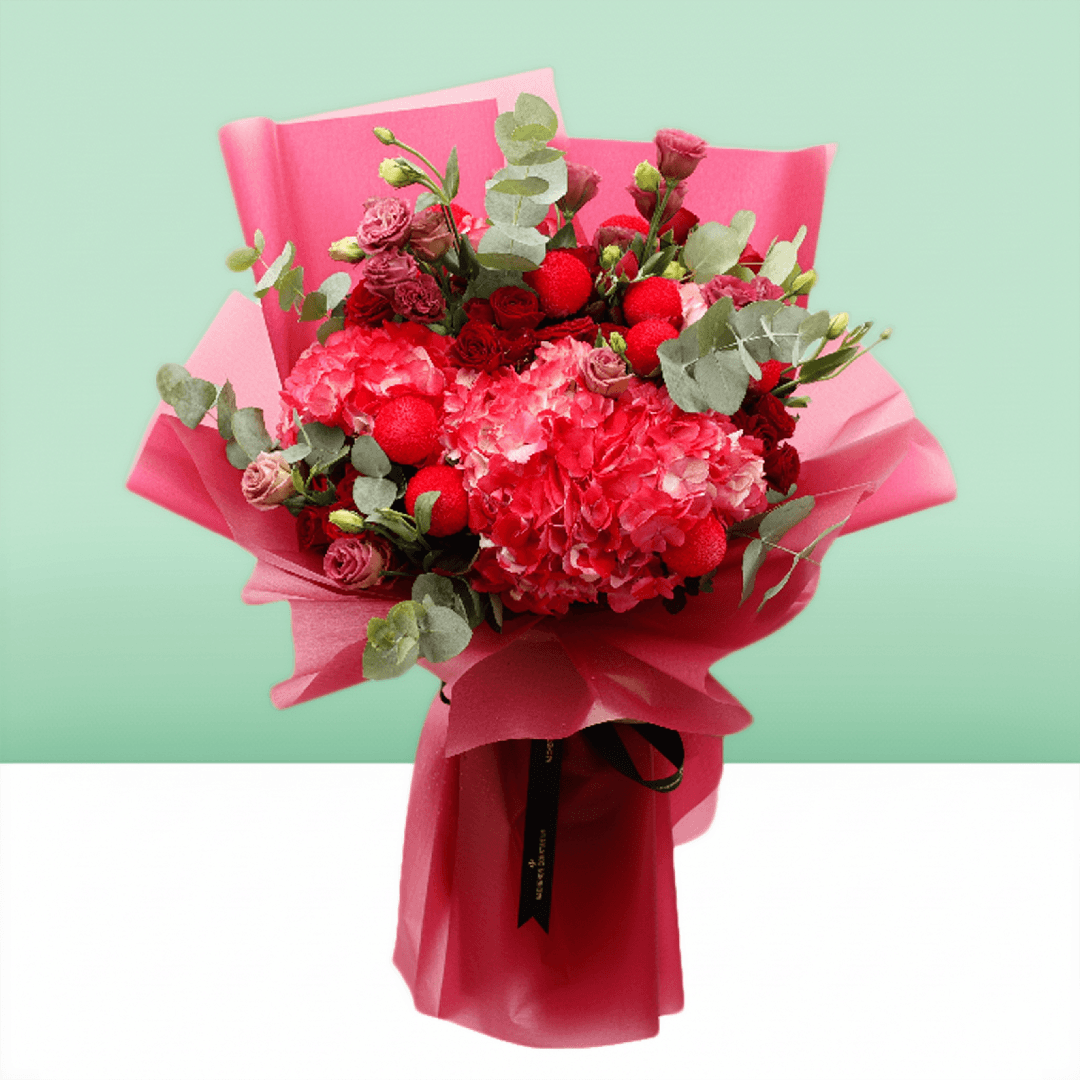Pink hydrangea, red spray roses and ping pong chrysanthemums bouquet with eucalyptus in bright pink wrapping