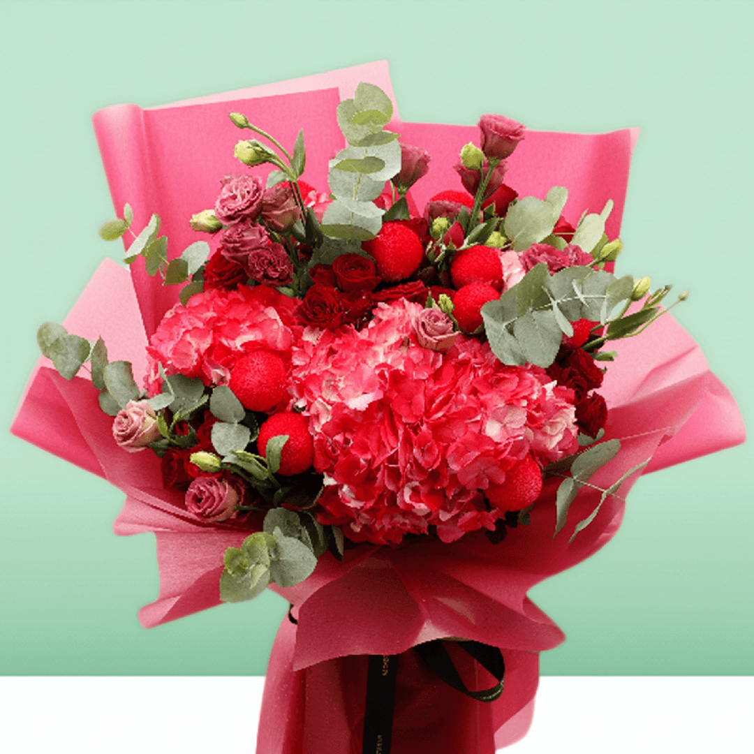 Pink hydrangea, red spray roses and ping pong chrysanthemums bouquet with eucalyptus in bright pink wrapping